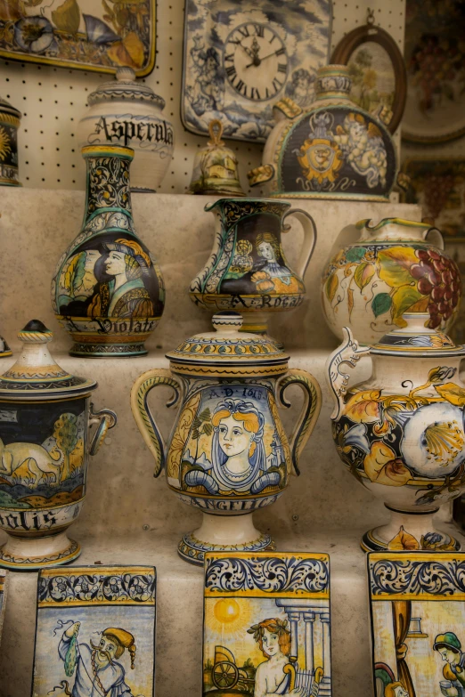 a large variety of vases on display with other items
