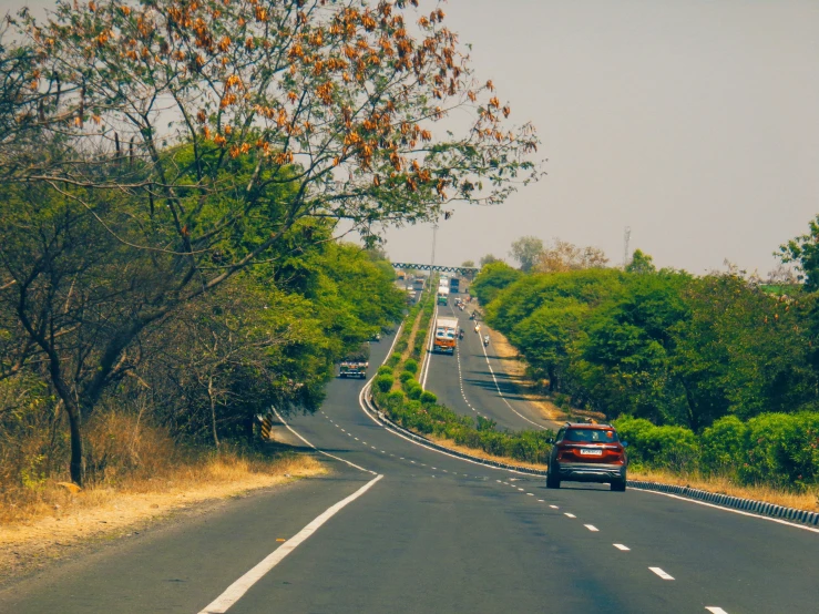 a long road with cars traveling down one of the sides