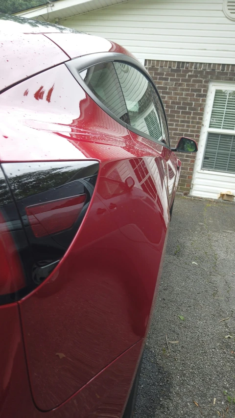 closeup of a shiny red car with the sun visor peeled off