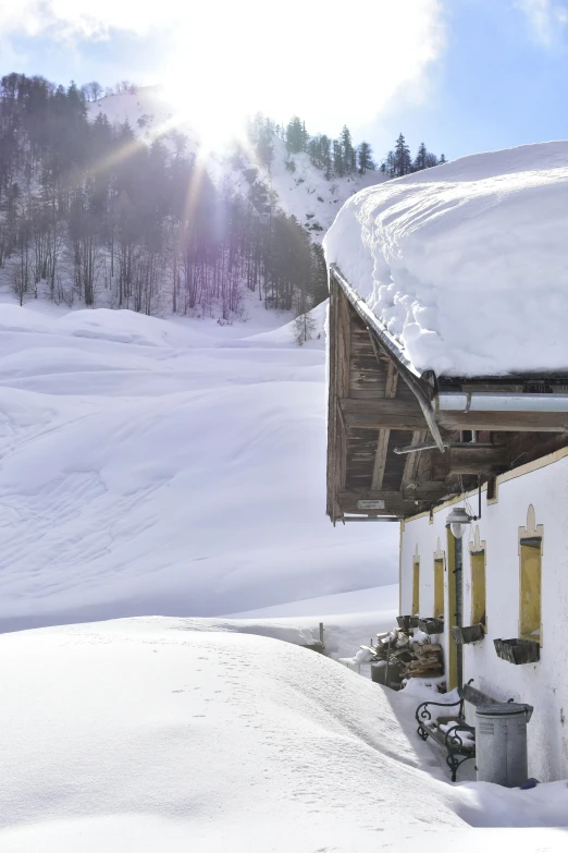 a snowy hill next to a house