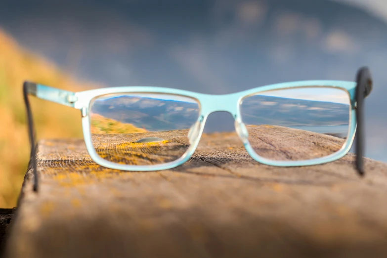 a pair of blue glasses with some dirt on them