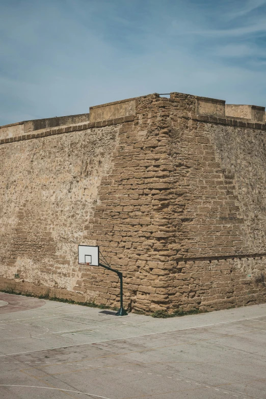 an old basketball court and a wall that has been made to look like it could be built