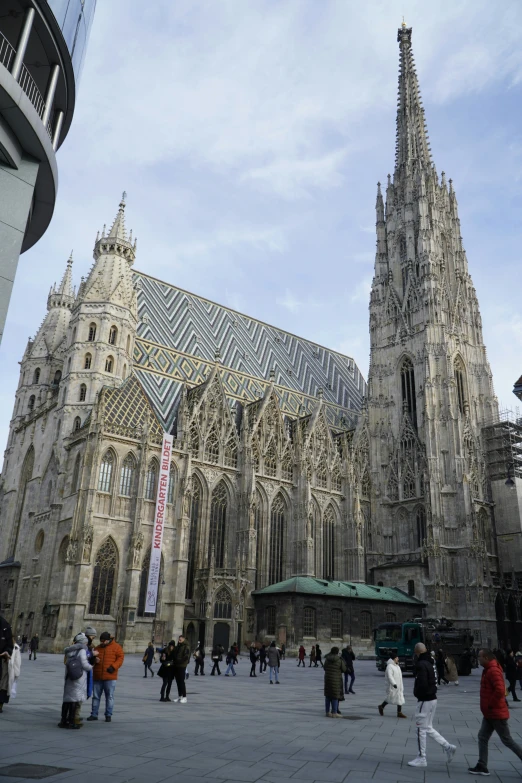 a large building with people walking on the street outside