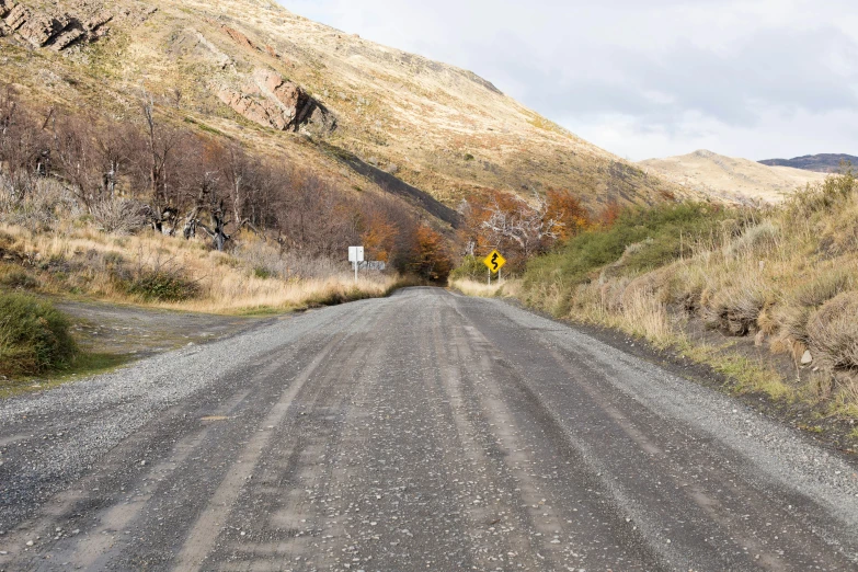 a dirt road that is between two hills