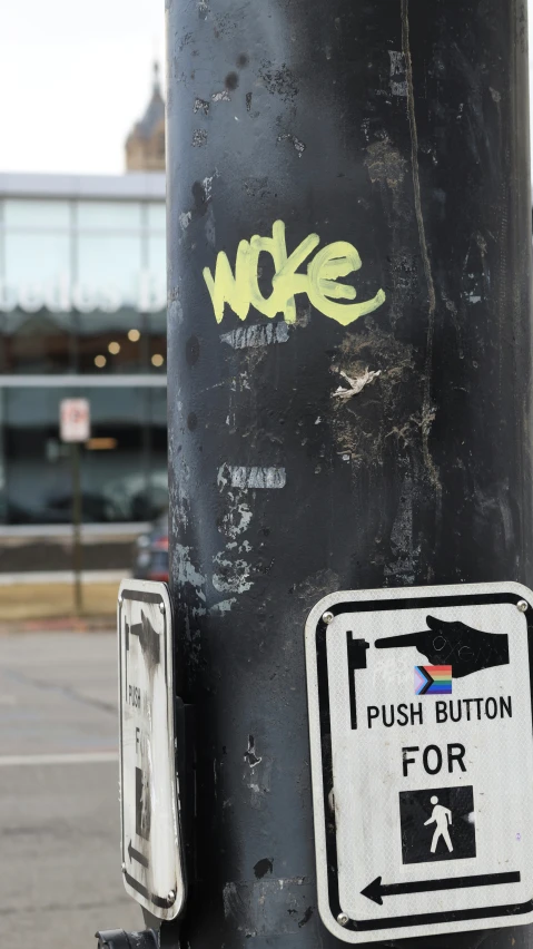 a street pole with some stickers on it