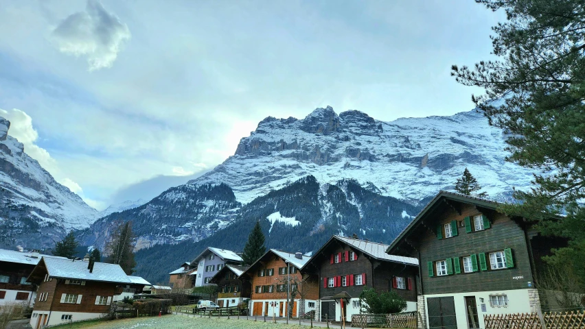 snow capped mountains in the background of small houses