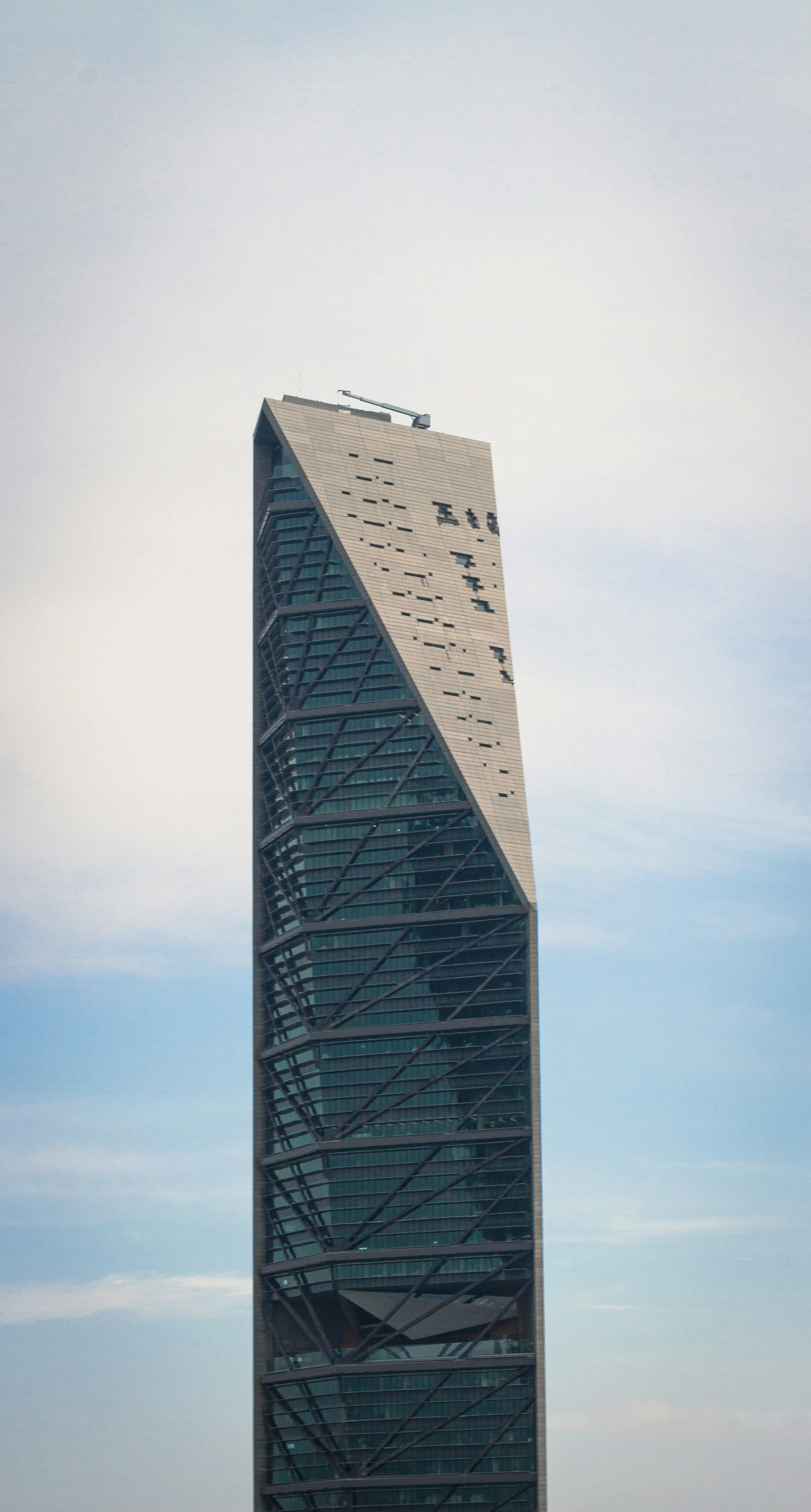 a large building sitting under a cloudy blue sky