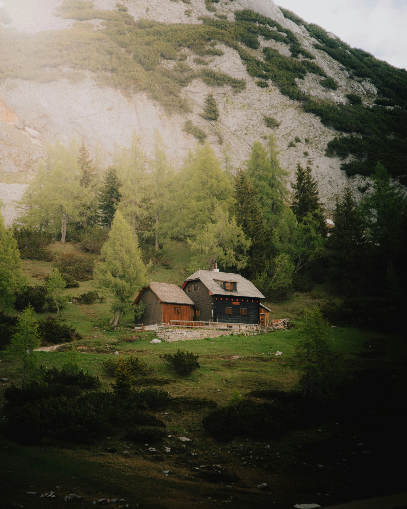 a mountain house on top of a large hill