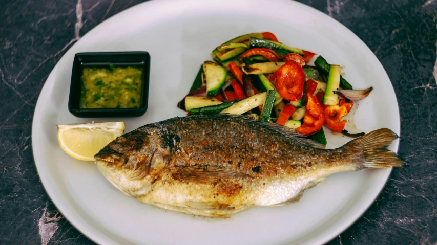 fish and mixed vegetables are on the plate