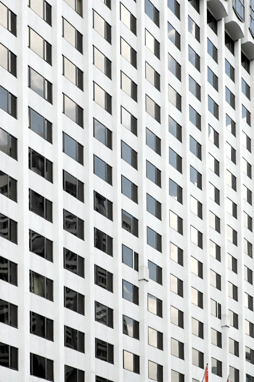 a tall white building with many windows and balconies