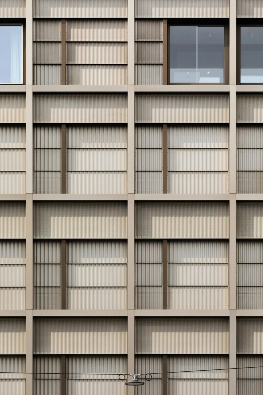 the side of a tall building with rows of windows