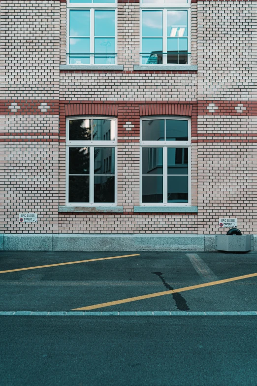 the corner of an empty parking lot with the windows partially closed