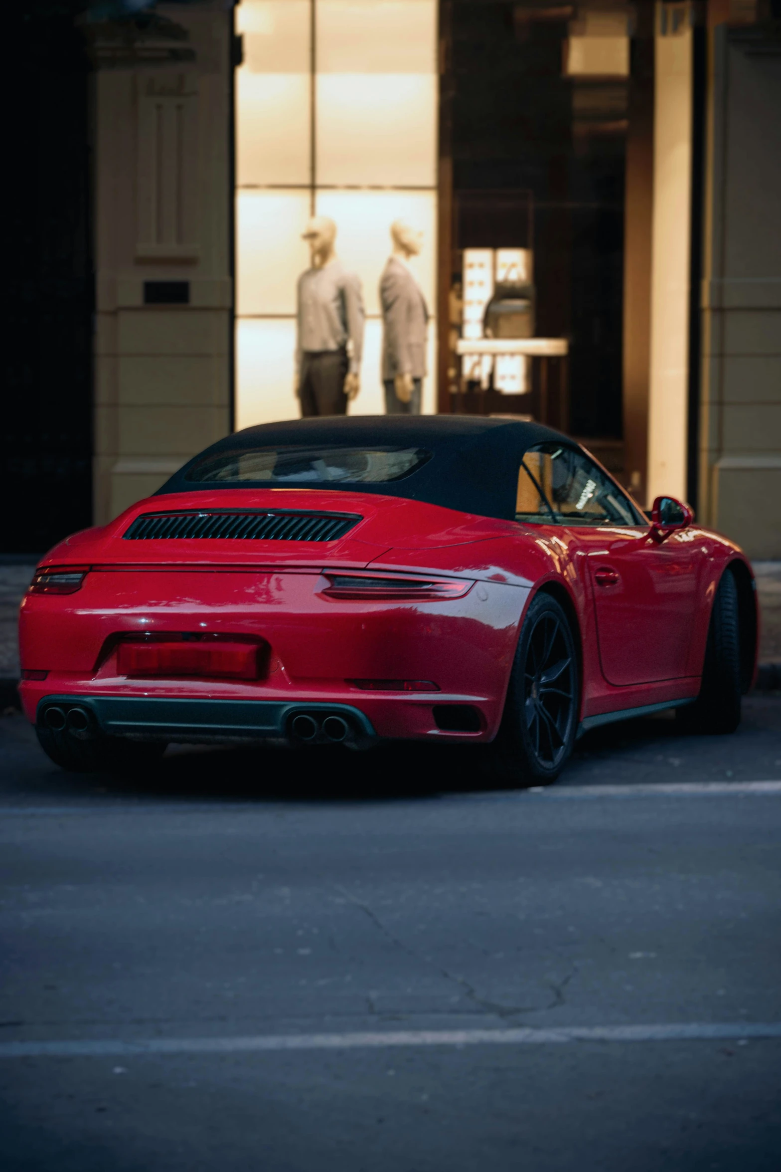 a red sports car parked next to a building