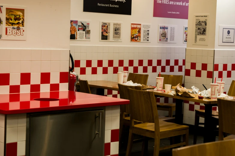 a restaurant with booths and tiled walls on the walls