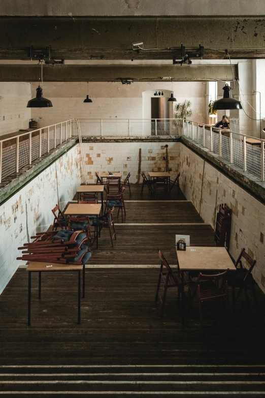 an empty, abandoned restaurant or cafeteria has wood floors