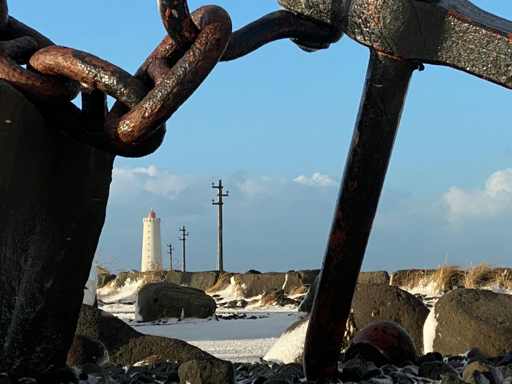 a large rusty piece of chain in a rock area