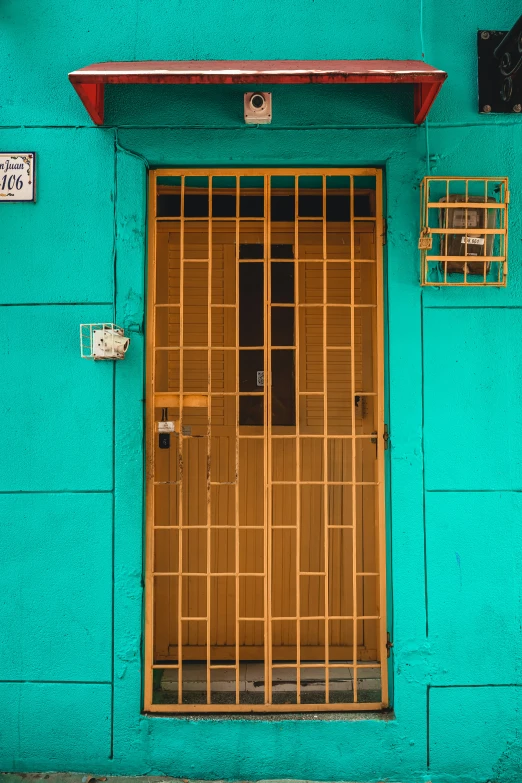 a blue building with a wooden door and window