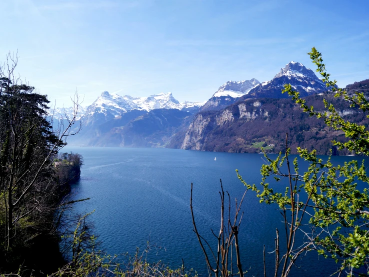 mountains and water are near the shore