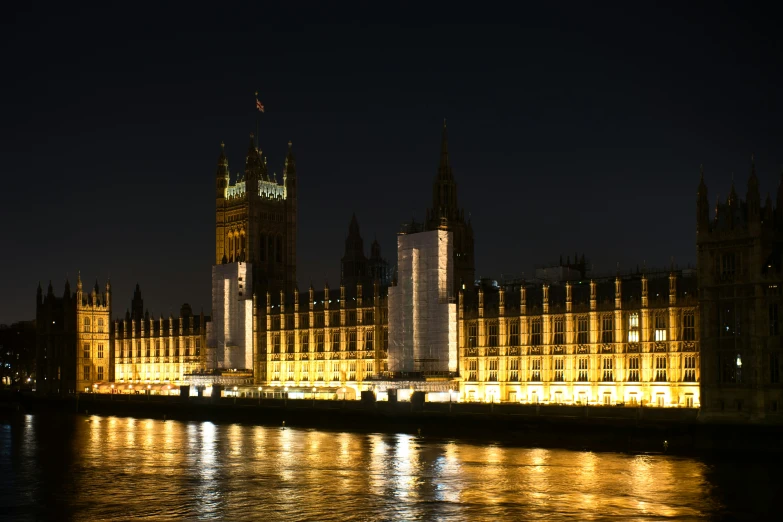 an old building with a spire lit up at night