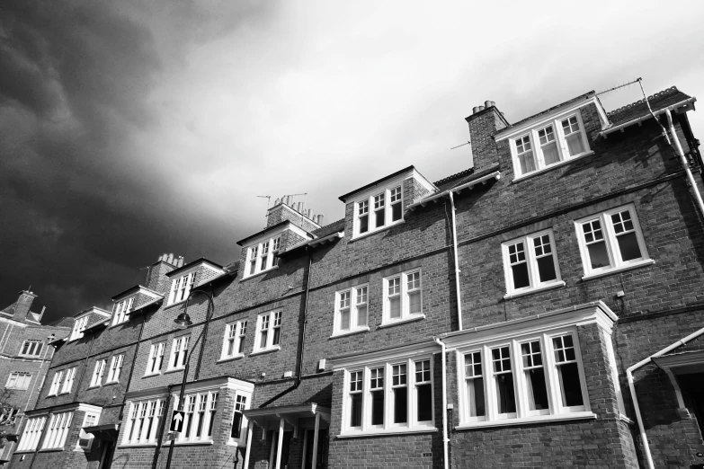 black and white image of a row of buildings against the sky