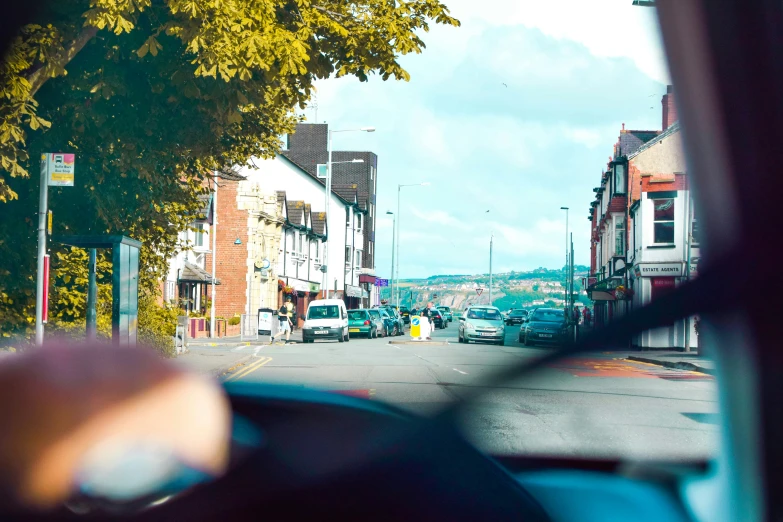 cars parked in front of small building on a street