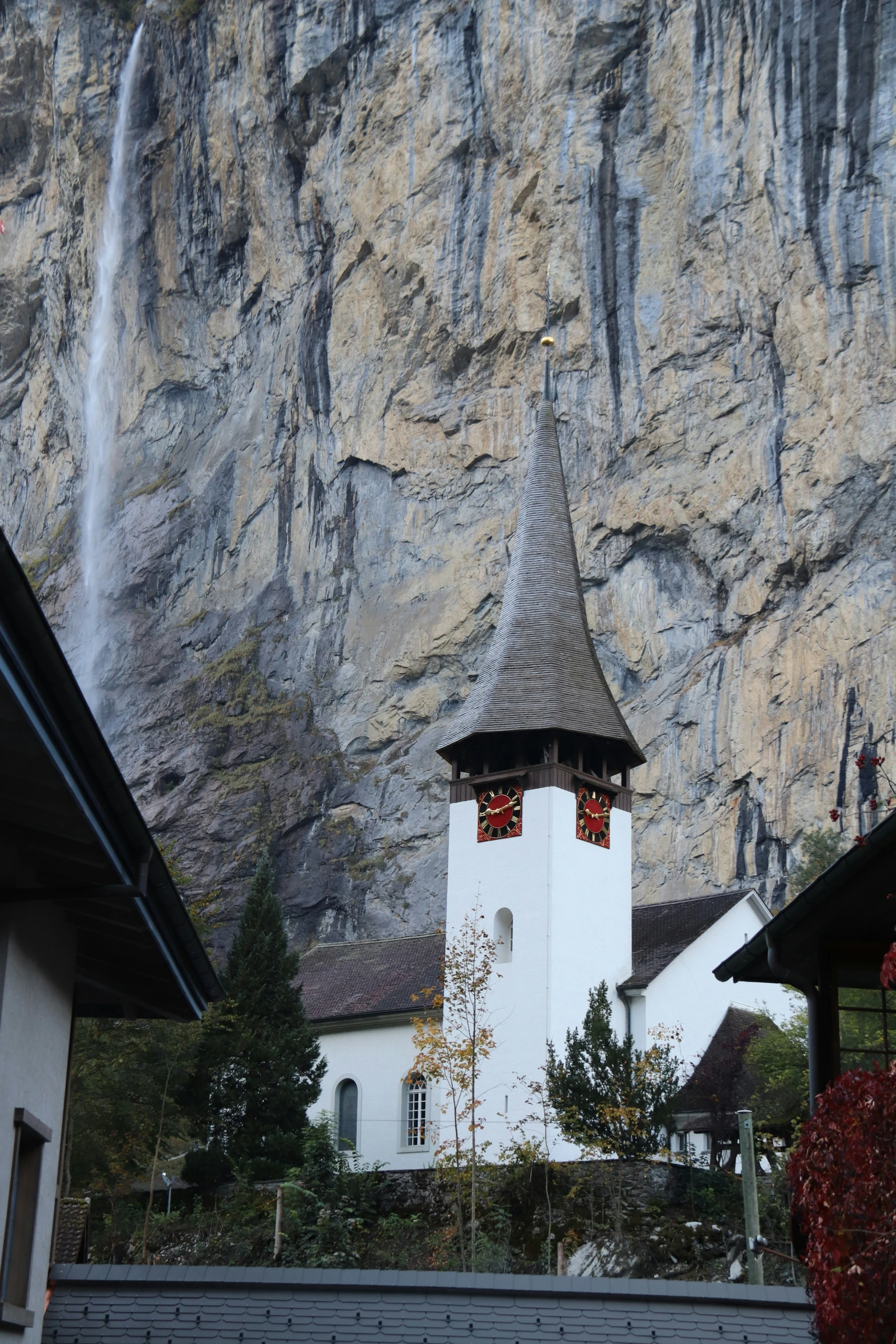 a white and black church and a cliff