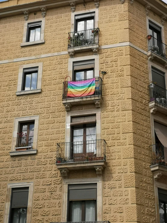 a very tall building with a few balconies on the second story