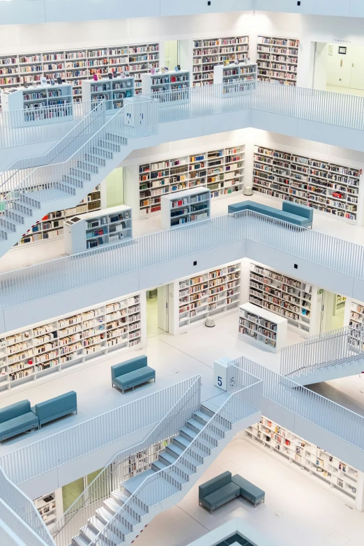 the inside of an all white liry is lit up by two large bookshelves