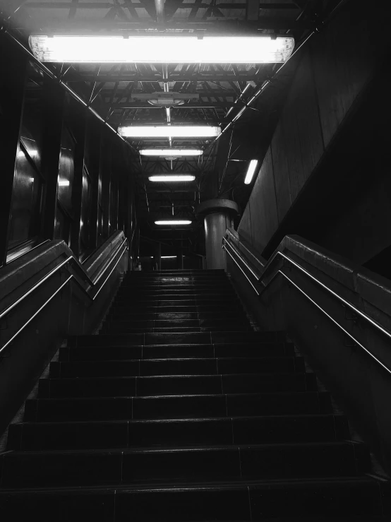 a po of some escalators with lights above them