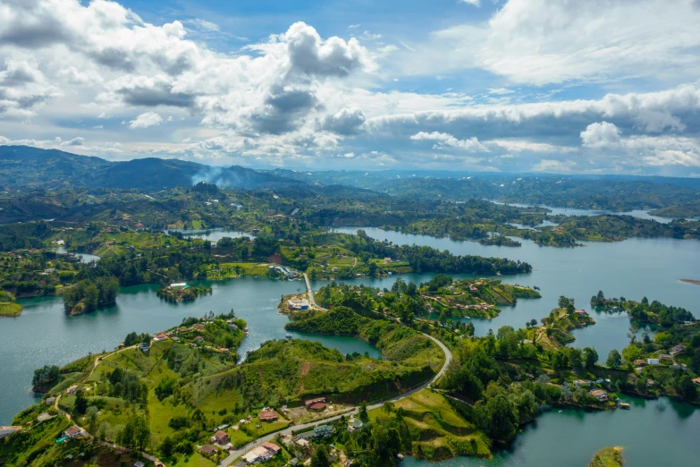 a wide lake surrounded by mountains under a cloudy sky