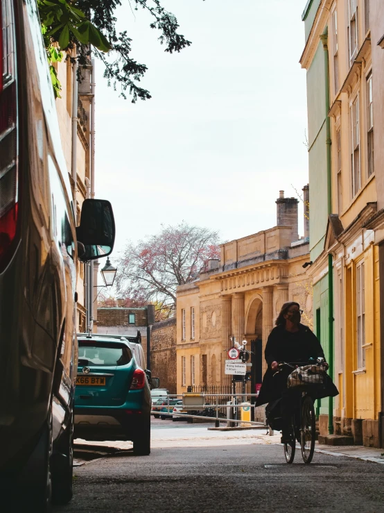 a man is riding a bicycle down an alley way