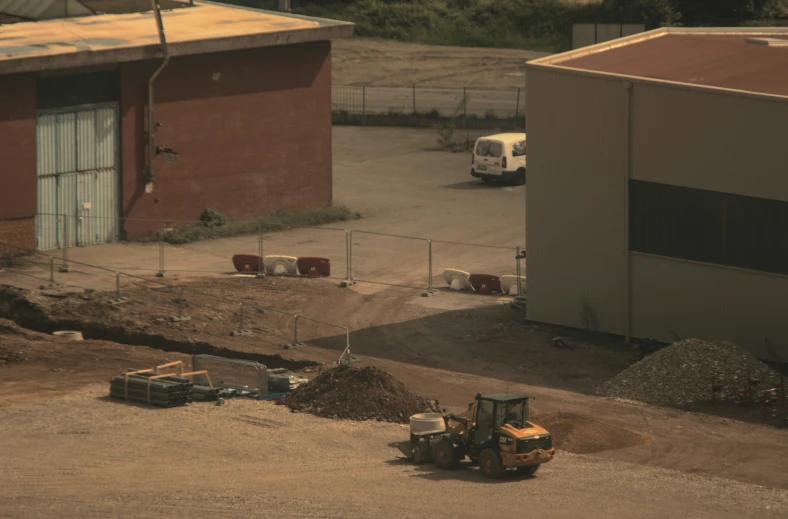 two work trucks in front of a large building