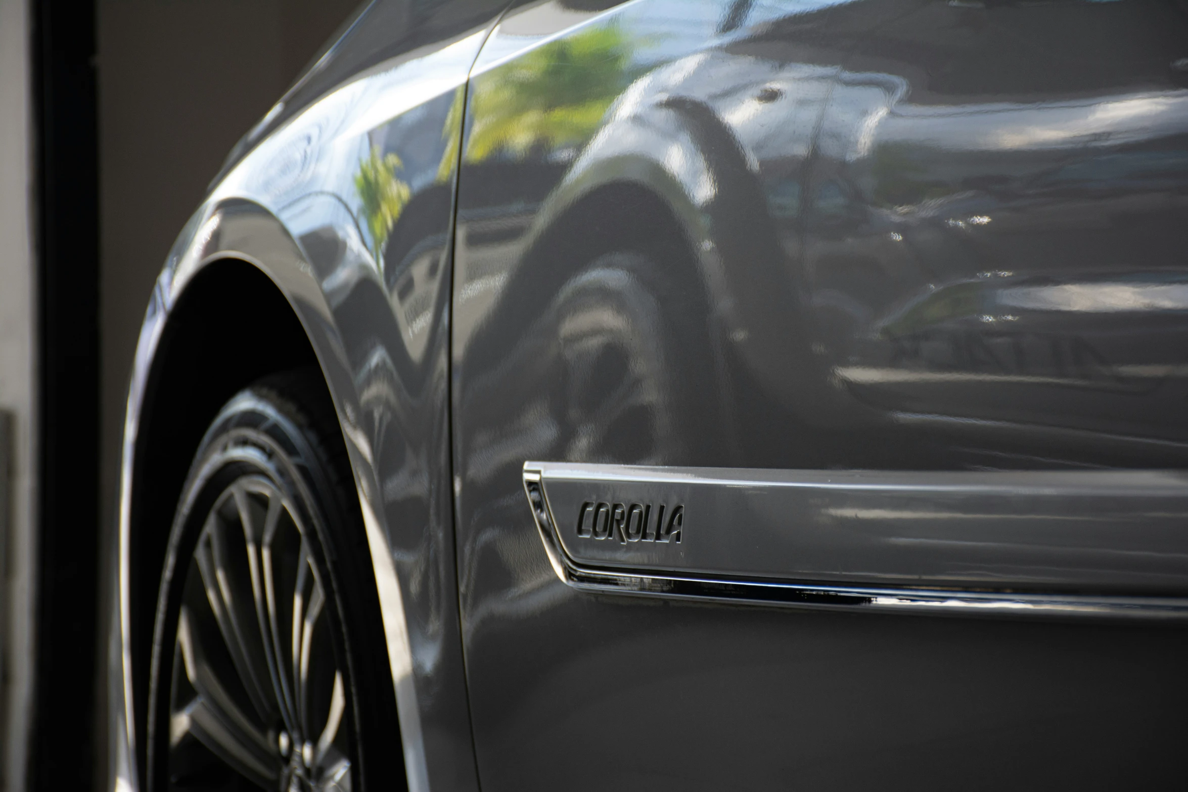 a close - up of the badge on the rear door of a luxury car