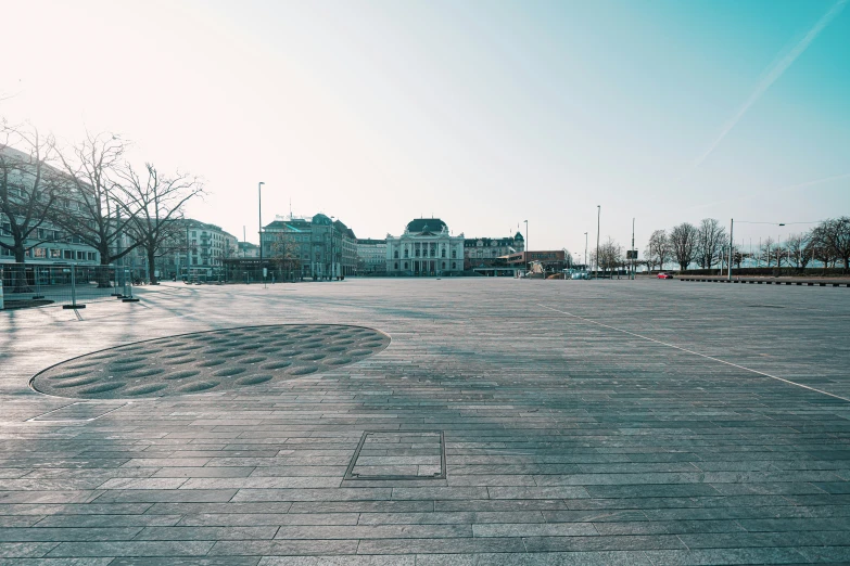 a empty street with some bricked in sidewalks and trees