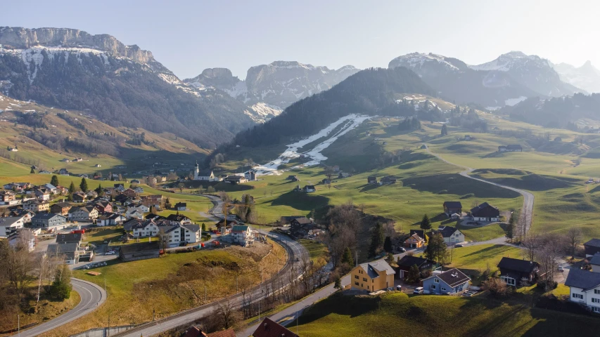 a town in the middle of a lush green valley