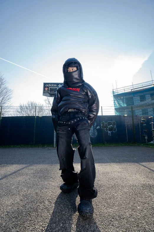 a man standing on a skateboard with one foot on his hip