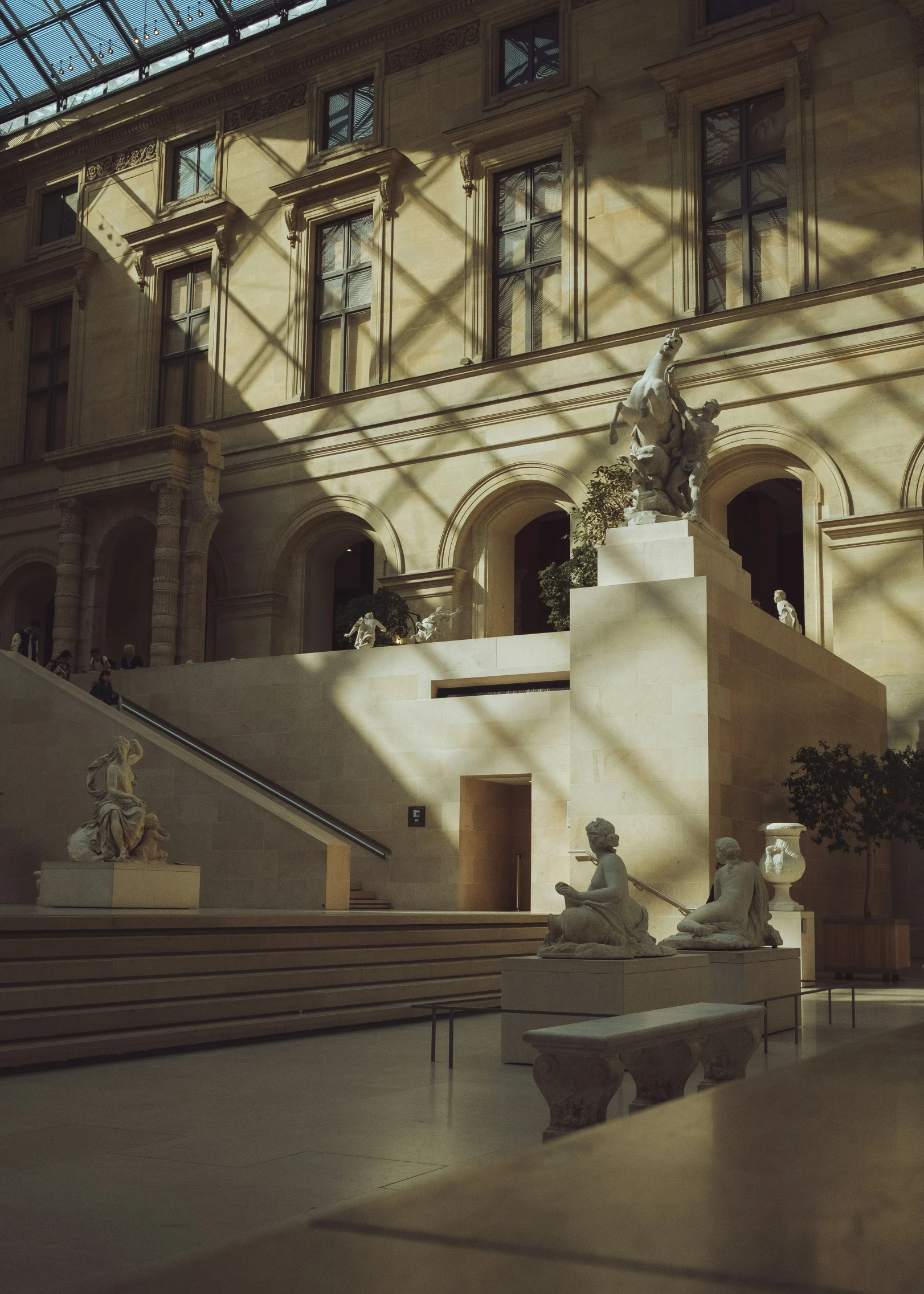 a statue sits outside of a building that has several windows