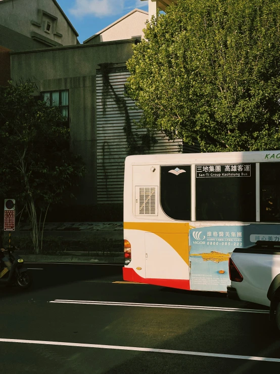 a man riding on a motorcycle near a city bus