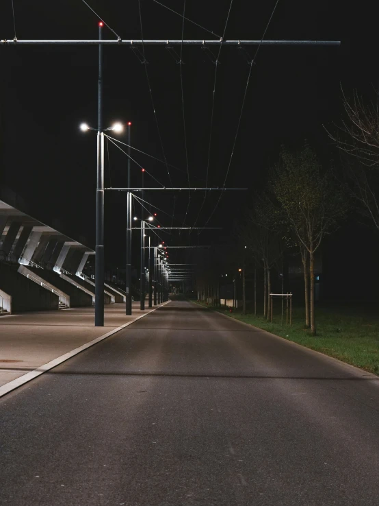 a city street at night lined with lots of street lights