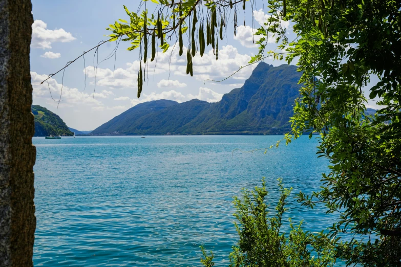 a lake is blue with water and mountains in the distance