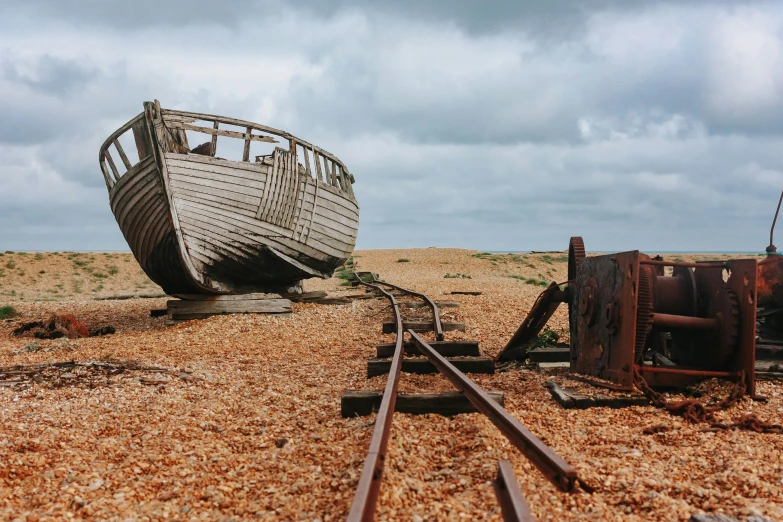 two old wooden ships sit on the beach