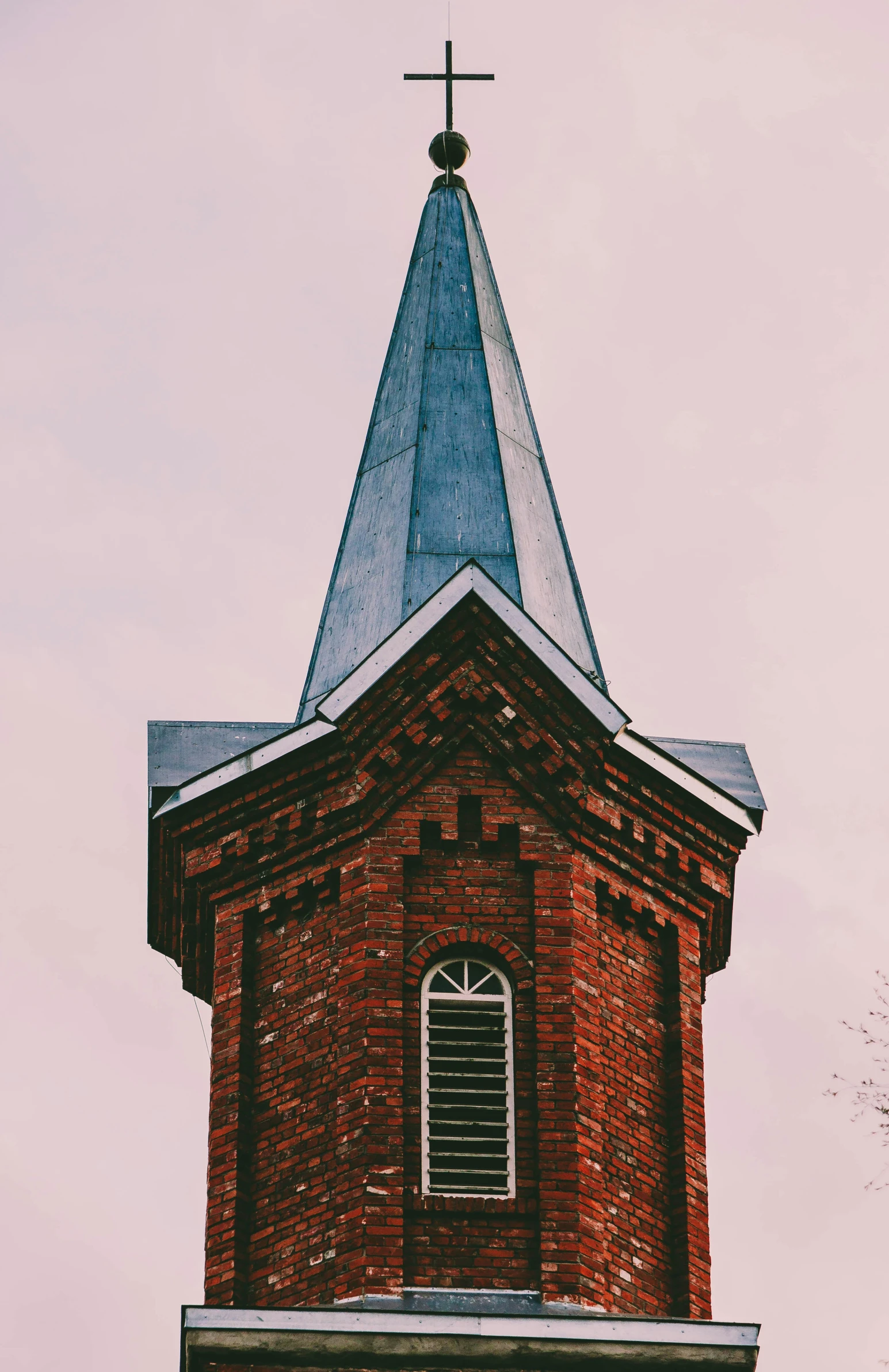 a large steeple has a steeple with a pointed out window