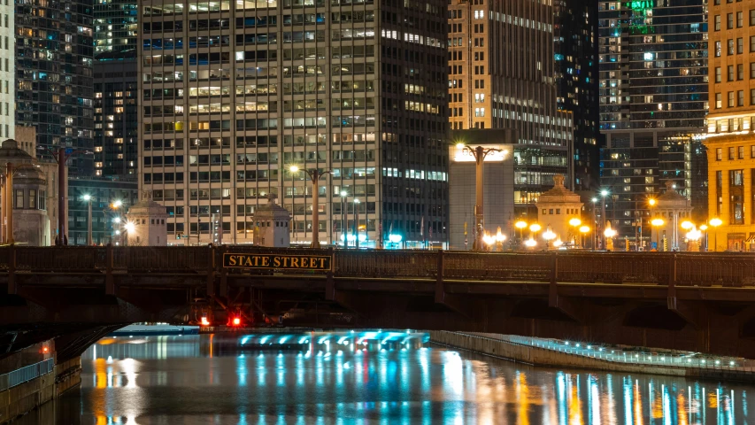 the skyline is illuminated in blue, green and yellow lights