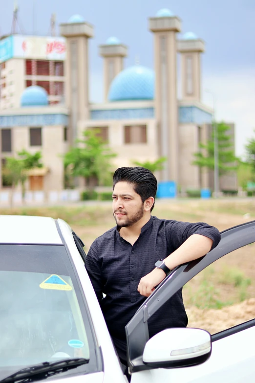 there is a man leaning on the side window of a car