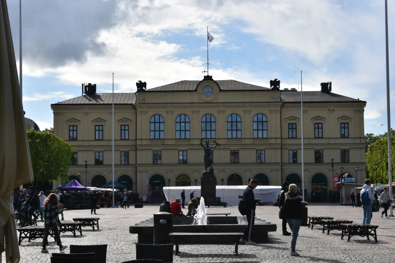 people walking around in front of a large building