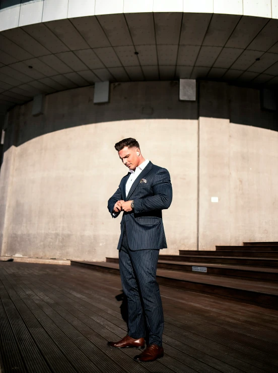 a man in a suit is standing on some stairs