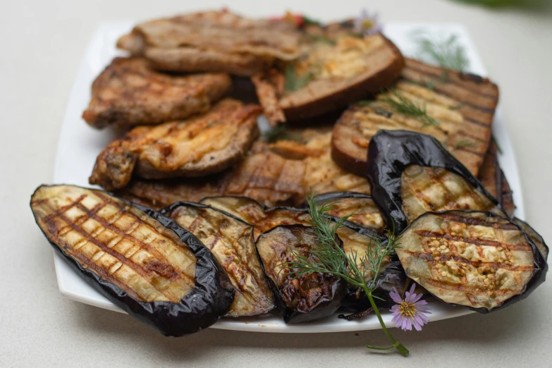 grilled eggplant and sliced banana arranged on a white plate