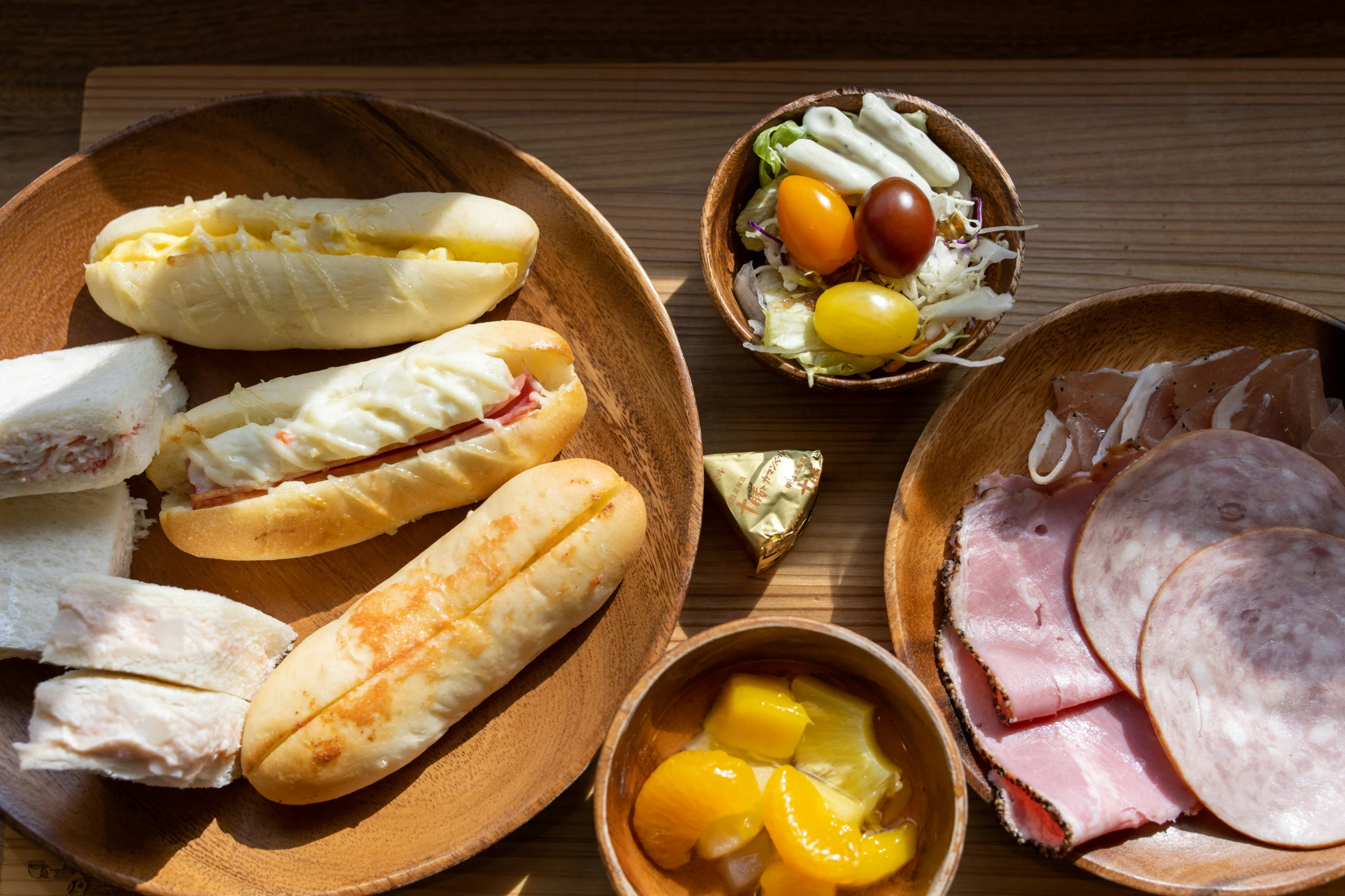 a table with two dishes containing meat and bread