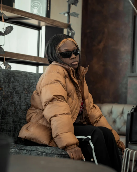 an african american woman in the street sitting on a couch