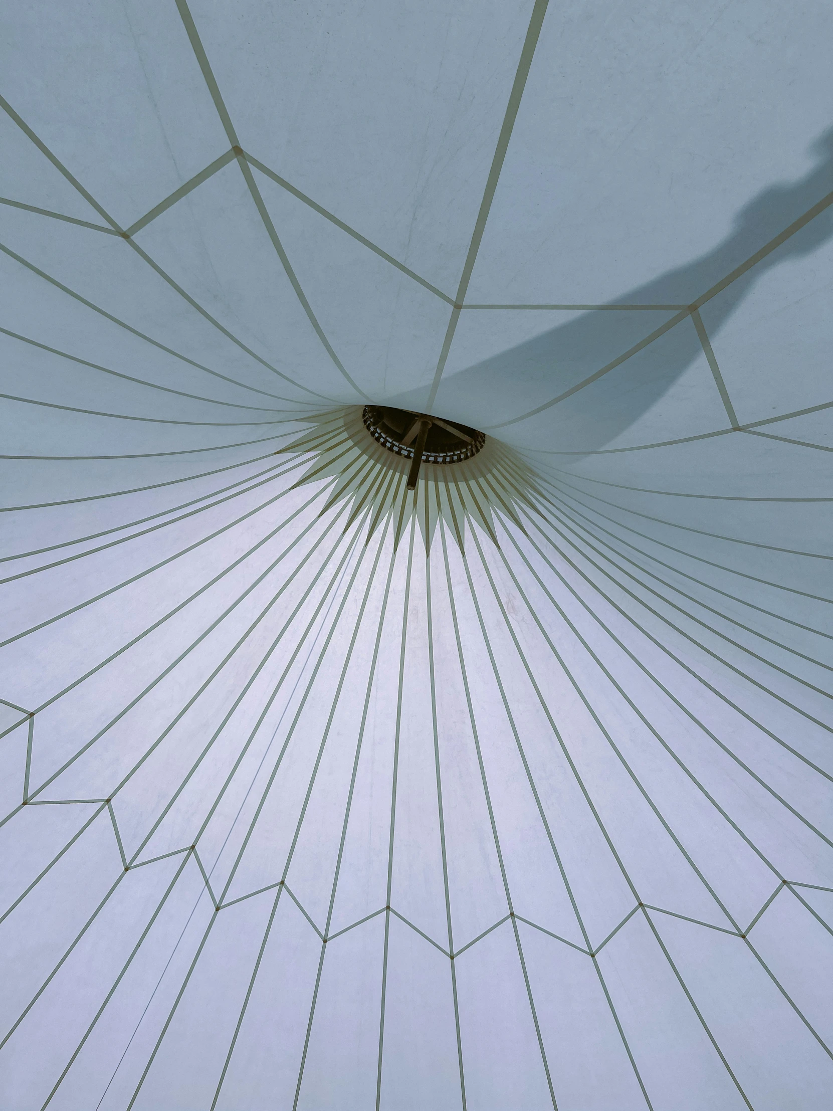 a large white umbrella with lines going through it